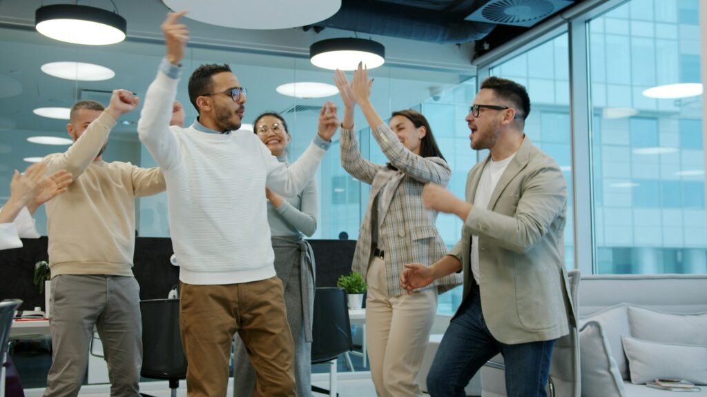 Team feiert gemeinsam einen Erfolg im Büro