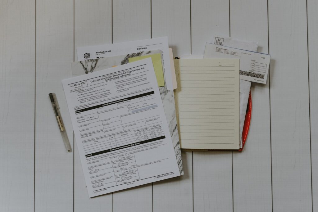 B2B-Inkasso: Unterlagen, Rechnungen und Notizen liegen ausgebreitet auf einem Schreibtisch