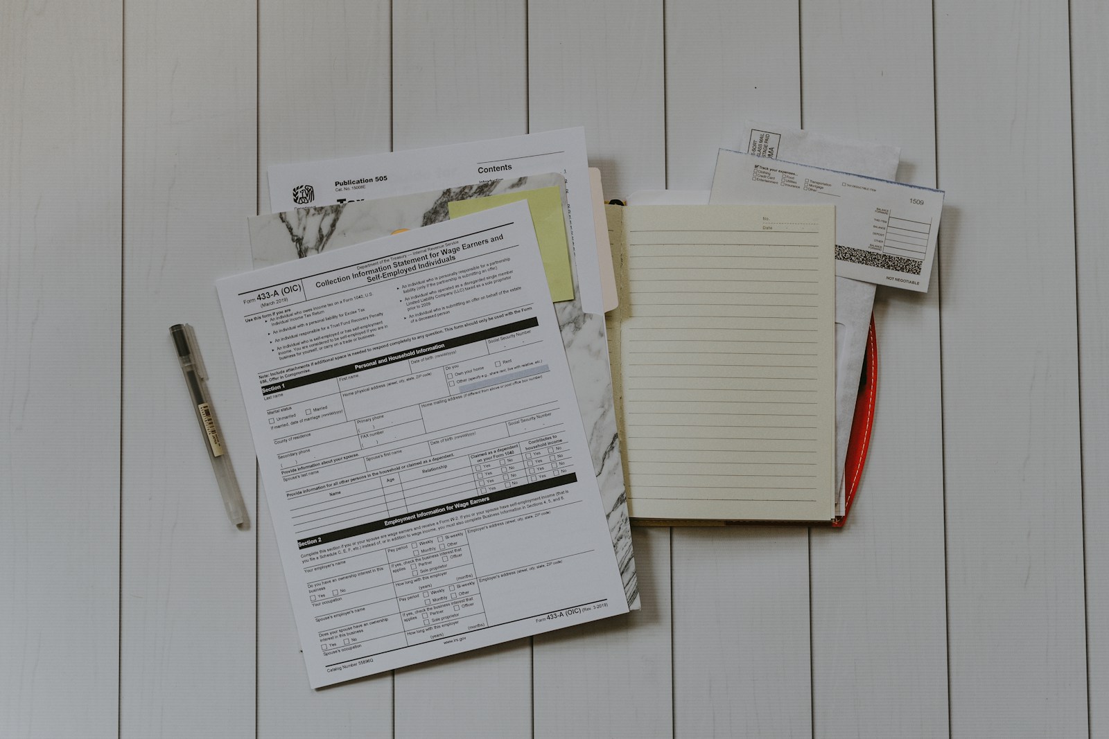 B2B-Inkasso: Unterlagen, Rechnungen und Notizen liegen ausgebreitet auf einem Schreibtisch